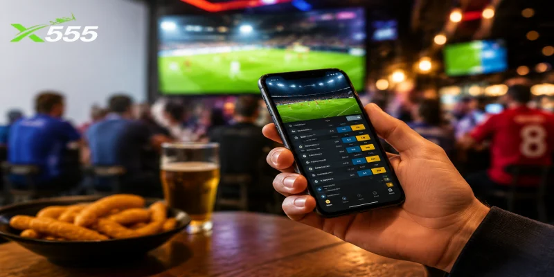 A smartphone displaying live sports betting odds on a mobile wagering application.